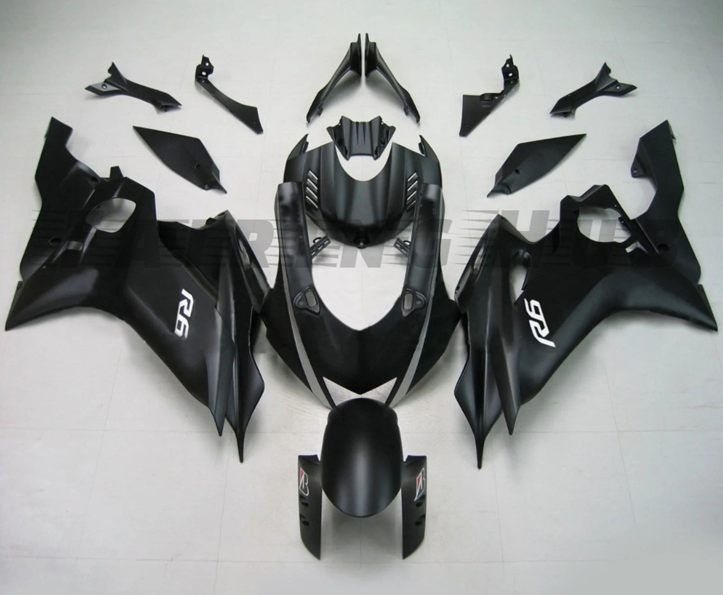 A matte black fairing kit for Yamaha R6 motorcycle, laid out on a white background. The kit includes various pieces for the front, sides, and rear of the bike.
